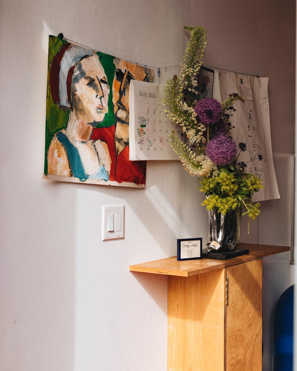 A wooden table topped with a vase filled with flowers