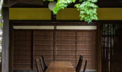 A wooden table sitting under a wooden roof